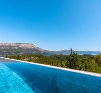 View from the villa in Korčula of the pool and mountains in the distance.