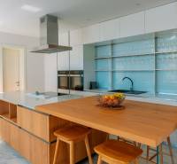 A kitchen in a villa with a wooden decor table and fruit in a bowl.