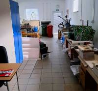 A workshop in a family house with equipment, workbenches, and cabinets in Nitra, Chrenová.