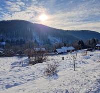 Winter landscape at Recreational Grounds in Fongrube, Mýto pod Ďumbierom with snow-covered houses and forests.