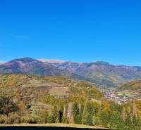 Beautiful autumn panorama of residential plots in Mýto pod Ďumbierom surrounded by mountains and forests.