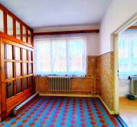 Interior of a family house with colorful tiles and wooden elements on the wall and doors.