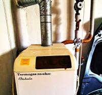 Gas boiler Termogas 25 eco with connected pipes in a family house.