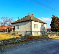 A family house on Sadová Street in Borský Mikuláš with a fenced garden and blue sky.