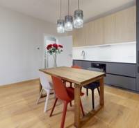 Bright living room in a 2-room apartment with a wood-patterned floor.