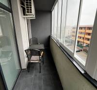 Glazed loggia of a 2-room apartment on Holubej Street in Senec with tiles and seating.