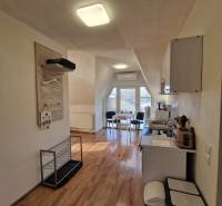 Interior of a family house with a kitchen and dining area, floor with wooden decor.
