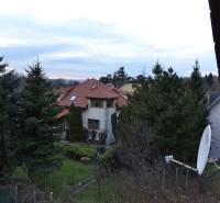 A family house on Jelenecká Street in Nitra surrounded by greenery and a satellite dish.
