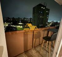 A night view from the balcony of a 2-room apartment in Nové Zámky onto the street Nové Zámky.