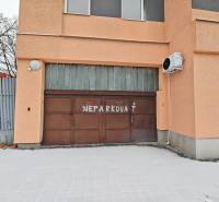 Garages on Hviezdoslavova Street in Michalovce with a no parking sign on the gate.