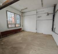 Interior of garages with a window and a grille, floor with wooden decor.