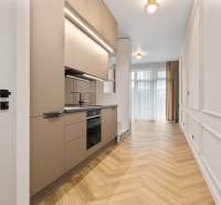 Kitchen in a 2-room apartment with a wooden decor floor and neutral colors.
