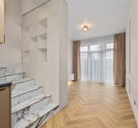 Interior of a 2-room apartment with marble stairs and a wooden decor floor.