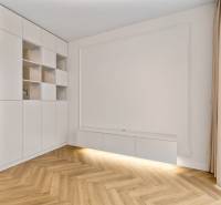 In the 2-room apartment, there is a white built-in wardrobe and a floor with a wooden decor.