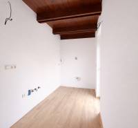 Interior of a family house with a wooden decor floor and a wooden beam ceiling.