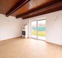 Interior of a family house with a wooden decor floor and large windows to the garden.