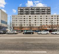 Building on Budatinská Street in Bratislava - Petržalka with cars parked in front of it.