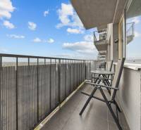 The balcony of a 2-room apartment on Budatinska Street in Bratislava-Petržalka, with a view of the countryside.