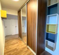 In the 3-room apartment, you can see a built-in wardrobe, a floor with a wooden decor, and shelves.