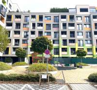Colorful apartment buildings on Nejedlého Street in Bratislava - Dúbravka, with a parking space.