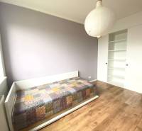 Children's room in a 3-room apartment with a bed and a floor with a wooden decor.