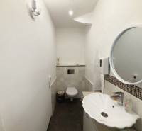 Restroom with a sink and mirror, located in commercial premises.