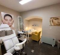 Commercial premises with chairs and wall decorations, floor with wooden decor.