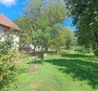 A family house in the village of Kalameny in Ružomberok, surrounded by greenery and fruit trees.