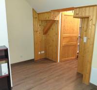 Interior of an office with wooden paneling and a wood-patterned floor.