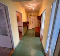 A hallway in a 3-room apartment with linoleum and colored walls.