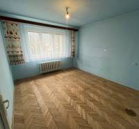 A blue room with a large window and a wooden decor floor in a 3-room apartment.