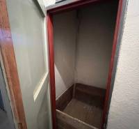 A small room with a wooden box in a 3-room apartment.