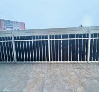 A balcony with tiles and metal railing in the center of Krásno nad Kysucou, 2-room apartment.