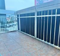 A balcony with a metal railing in a 2-room apartment, overlooking Centrum Street in Krásno nad Kysucou.