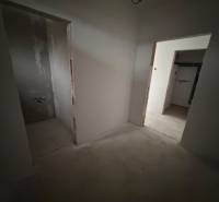 Interior of a family house with two unfinished rooms and an incomplete floor.