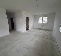 Interior of a family house with white walls and concrete floor.