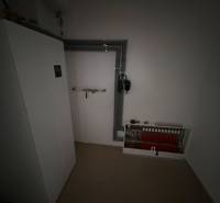 Boiler room in a family house with a heating system and pipes on the wall.