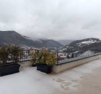 Winter view of snow-covered hills in the town of Nová Baňa from the balcony of a 2-room apartment.
