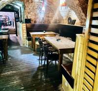 Stone walls and a wooden-patterned floor create a cozy atmosphere in the dining area.