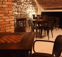 Rustic gastro spaces with stone walls and wooden decor flooring.