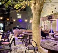 Exterior Gastro spaces on Sedlárska Street in Bratislava - Historic core with wooden seating.
