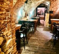Stone arches, wooden tables, and a wooden decor floor in dining areas.