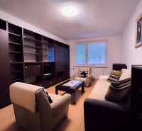 Living room with a sofa, armchairs, a coffee table, and a set in a 2-room apartment.