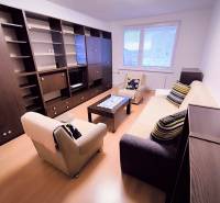 Living room in a two-room apartment with a sofa, armchairs, and a furniture set.