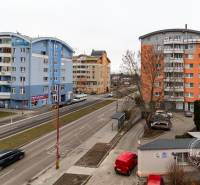 Kazanská Street in Bratislava - Podunajské Biskupice with colorful apartment buildings and traffic.