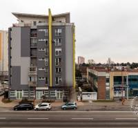 Apartment buildings on Kazanská Street in Bratislava - Podunajské Biskupice with traffic noise on the road.