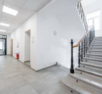 Interior with a stone staircase and hallway.