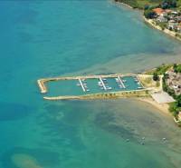 Aerial view of the coast of the town Ljubač with a harbor and houses along Ljubač street.