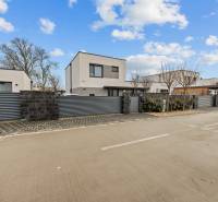 New buildings with a garage on Topoľová Street in Rovinka, surrounded by a modern fence.