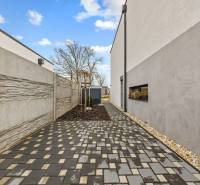 Paved path along the house on Topoľová Street in Rovinka.